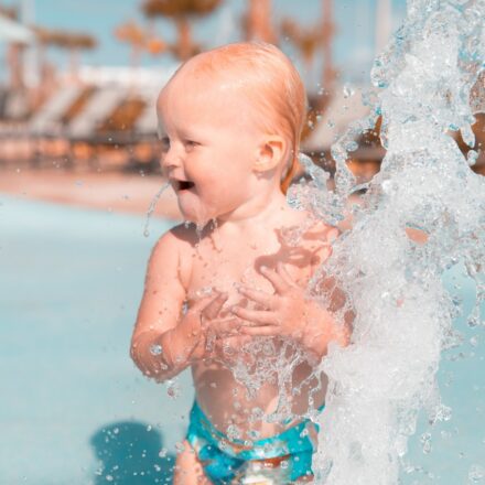 young kid playing in pool